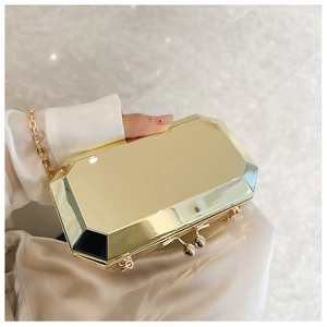 Macro view of golden octagonal acrylic clutch with metallic finish and sphere clasp