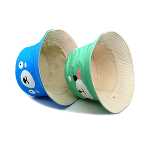 Kids cartoon bear print bucket hats in sky blue and mint green with cotton canvas texture