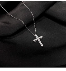 Macro shot of silver stainless steel cross pendant with sparkling zircon stones