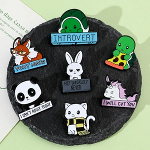Detailed macro shot of 7 enamel animal pins with funny quotes on a grey stone base