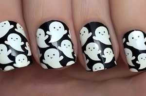 Macro shot of Halloween ghost pattern on short black and white press-on nails