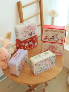 Christmas tinplate candy storage boxes featuring assorted festive cartoon rabbit patterns
