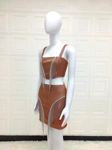Detail of glitter brown two-piece set featuring sequin fabric and silver fringe trim