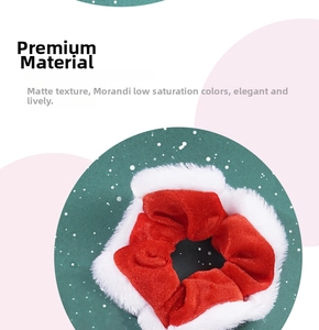 Close-up of red velvet scrunchie with white plush trim and sparkling sequin bow detail