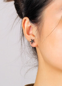 Detail of vintage silver starfish stud earring worn on model for a trendy summer look