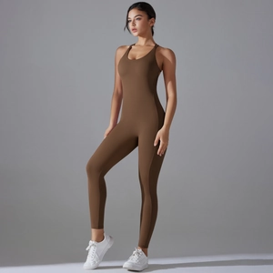 Detail view of deep brown seamless yoga jumpsuit with cross-back straps and butt-lifting fit
