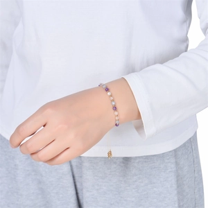 Gros plan d'un bracelet de perles ajustable avec pierres multicolores sur le poignet