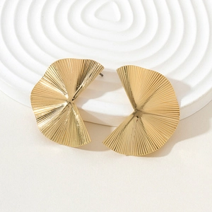 Macro view of gold pleated fan-shaped earrings with fine vertical ribbed textures