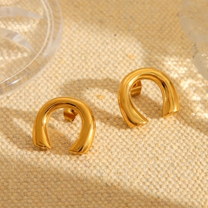 Polished 18K gold plated U-shaped stainless steel earrings on a textured fabric