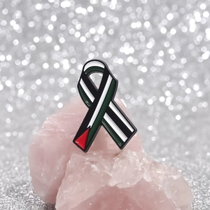 Creative Palestine flag ribbon enamel brooch pin on pink crystal stones background