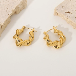 Detailed view of gold plated twisted hoop earrings with elegant spiral metal texture
