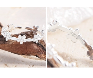 Macro shot of S925 sterling silver flower ring showing intricate hallmarking and details
