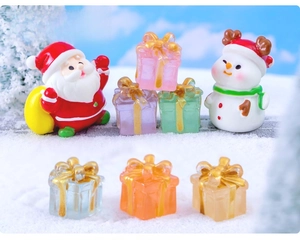 Miniature resin Santa Claus and colorful luminous gift boxes on snow for DIY micro landscapes