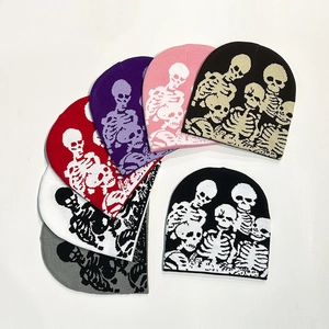 Knitted skull beanies for Halloween party shown in seven colors on white background