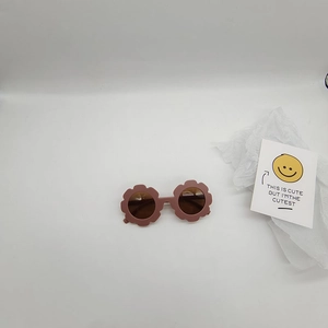 Detailed view of lavender purple flower-shaped sunglasses for kids on a white background