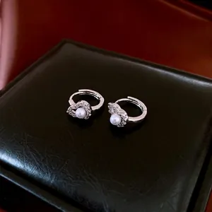 Elegant silver hoop earrings with hollow gourd pearl charms and sparkling cubic zirconia