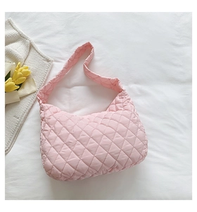 Detailed view of pink quilted nylon shoulder bag with soft puffy diamond stitching