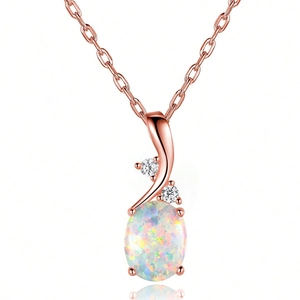 Detail view of oval opal pendant necklace with zircon accents in rose gold plating