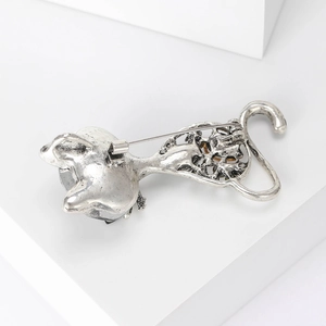 Detailed back view of a silver cat brooch showing the secure metal pin fastener