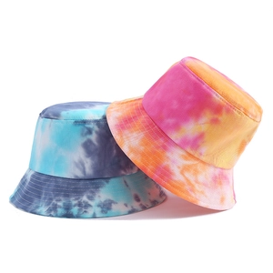 Detail of two foldable tie-dye bucket hats in blue and orange gradient color options