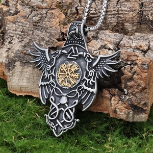 Viking raven compass pendant necklace in antique silver and gold on natural mossy bark