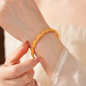 Detail of vintage gold brushed bracelet featuring sparkling micro-inlaid crystals on wrist