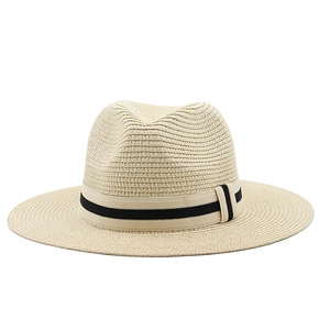 Close-up detail of beige Panama straw hat featuring a striped elastic band decoration