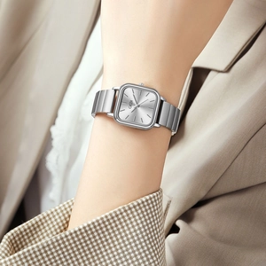 Elegant square silver quartz watch with metallic mesh band for women on model wrist