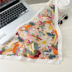 Detailed close-up of 100% cotton floral triangular scarf with white lace trim details