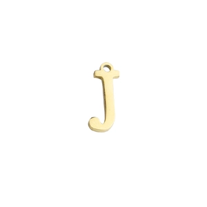 Detail of mirror-polished gold stainless steel lowercase letter j charm pendant