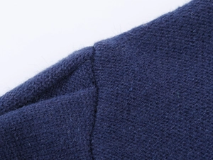 Close-up of high-quality navy knit fabric showing detailed stitching and soft texture