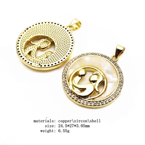 Macro view of gold mom heart pendant with copper, zircon, and shell inlay details