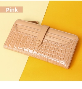 Detail of pink long wallet showing faux crocodile texture and multi-slot card holder design