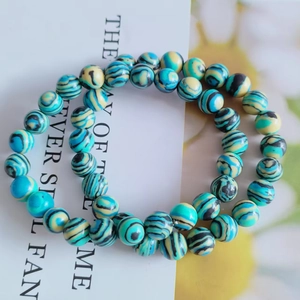 Close-up of double-loop 8mm cat eye stone bracelet with blue-green striped beads