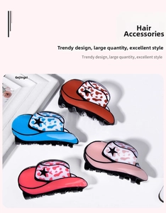 Detail of four colorful cowboy hat hair claws with star and cow print patterns