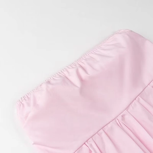 Detailed close-up of pink strapless top showing elastic waistband and fabric texture