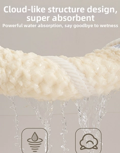 Detailed view of spiral texture on beige microfiber hair towel with water splashing effect