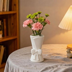 Modern white ceramic vase with bow tie design and textured bouquet paper shape