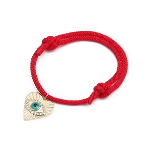 Adjustable red rope bracelet with heart-shaped evil eye pendant and zircon accents
