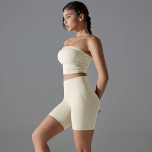 Detail view of high-elastic beige yoga set featuring tube top and high waist sports shorts