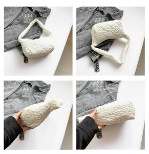 Detailed close-up of white quilted flower texture on minimalist shoulder underarm bag