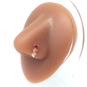 Gold nose stud with three colored heart-shaped crystals on professional silicone model