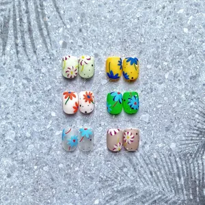 Close-up of assorted floral nail stickers in lemon yellow and pastel tones