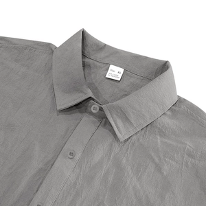 Close-up of gray linen shirt collar with XL size tag showing 95% linen material