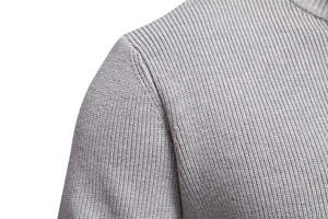 Detailed macro view of the grey ribbed knit texture and stitching on men's half-zip sweater