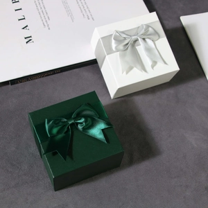 Square jewelry gift box set in white and dark green colors with elegant ribbon bow decoration