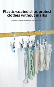 Detail of blue dipped stainless steel clips hanging socks on a rod for storage