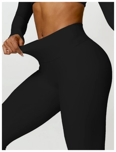 Close-up of high-waist yoga leggings showing tummy control and stretchy fabric texture