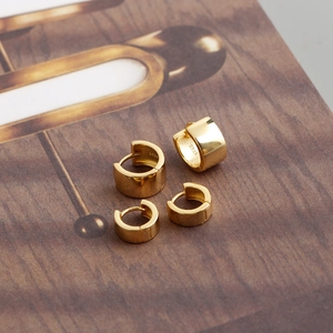 Detailed macro view of gold plated wide hoop earrings featuring the S925 silver hallmark