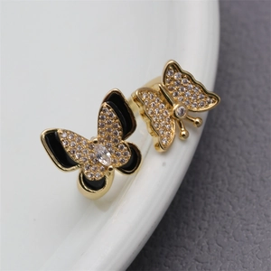 Macro shot of gold butterfly ring featuring black enamel and micro-pave cubic zirconia